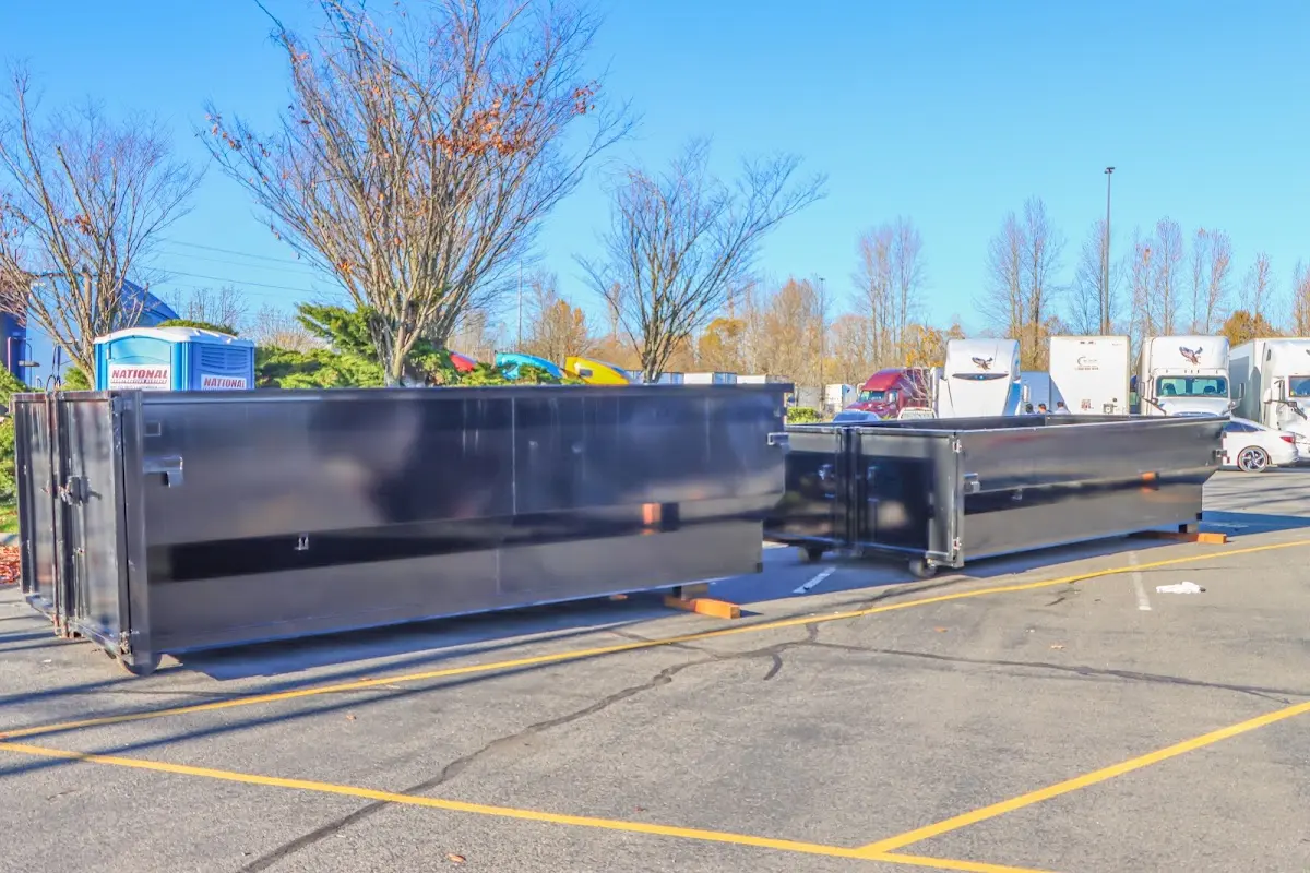 Professional dumpster rental service with roll-off container on residential driveway in Holladay